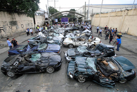 A bulldozer destroys condemned smuggled luxury cars worth 61 626 000 pesos (approximately US$1.2 million), which include used Lexus, BMW, Mercedes-Benz