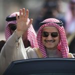 In this Feb. 4, 2014 file photo, Saudi billionaire Prince Alwaleed bin Talal waves as he arrives at the headquarters of Palestinian President Mahmoud Abbas in the West Bank city of Ramallah. Three associates of Saudi Prince Alwaleed bin Talal say the billionaire investor has been released after nearly three months in detention at a luxury hotel as part of an anti-corruption sweep. The associates told The Associated Press that the prince was released on Saturday Jan. 27, 2018.