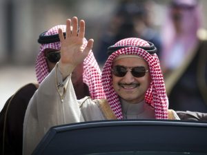 In this Feb. 4, 2014 file photo, Saudi billionaire Prince Alwaleed bin Talal waves as he arrives at the headquarters of Palestinian President Mahmoud Abbas in the West Bank city of Ramallah. Three associates of Saudi Prince Alwaleed bin Talal say the billionaire investor has been released after nearly three months in detention at a luxury hotel as part of an anti-corruption sweep. The associates told The Associated Press that the prince was released on Saturday Jan. 27, 2018.