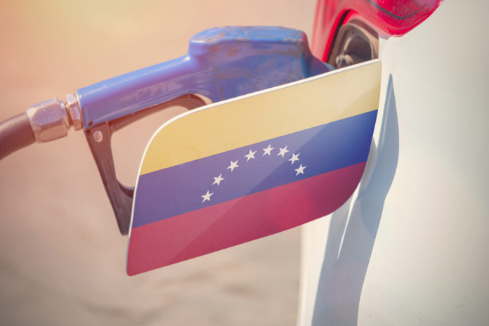 Gas pumped into the car with the Venezuelan flag on its fuel cap